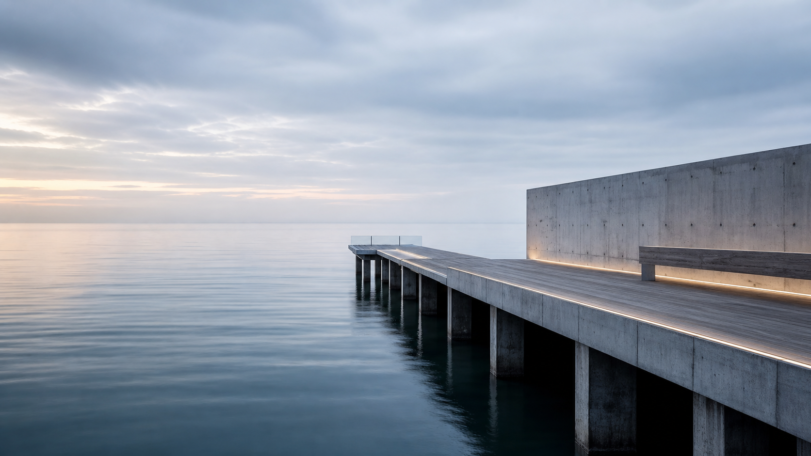 Architectural pier extending into calm blue water